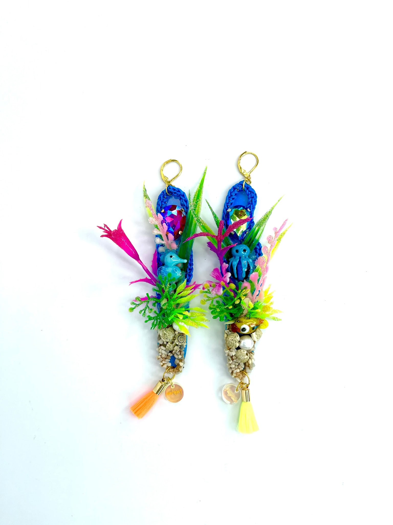 Blue crochet earrings in a long oval shape of 12cm, with a colourful under the sea theme including aquarium plants, glass seahorse, small gravel with seashells real pearl and small tassel. 2nd earring is similarly themed with aquarium plants, blue glass octopus and tiny yellow glass fish, with gravel pearl and tassels